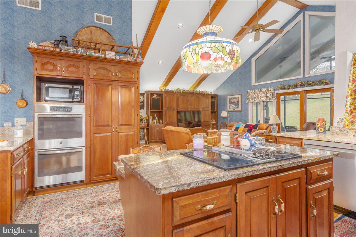 19850 Cool Hollow Road Hagerstown, MD 21740 - Photo 17 of 63 a kitchen with stainless steel appliances granite countertop a stove and cabinets