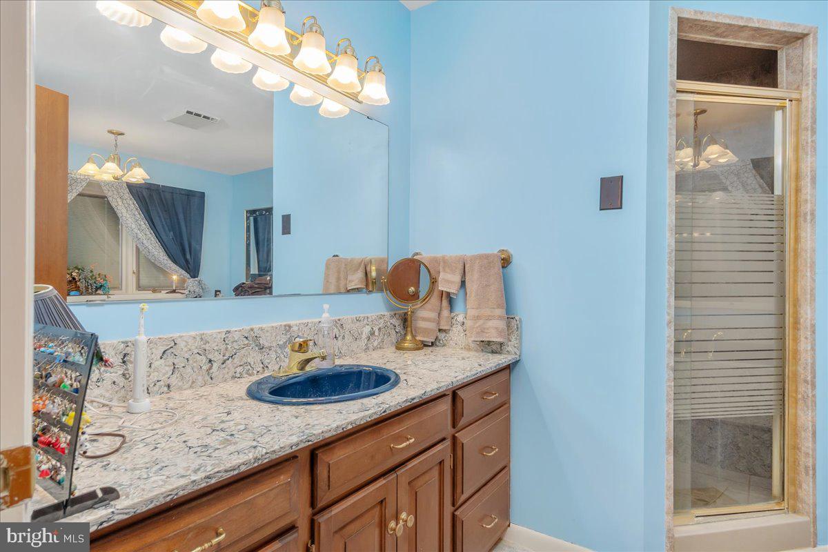 19850 Cool Hollow Road Hagerstown, MD 21740 - Photo 24 of 63 a bathroom with a granite countertop sink and a mirror