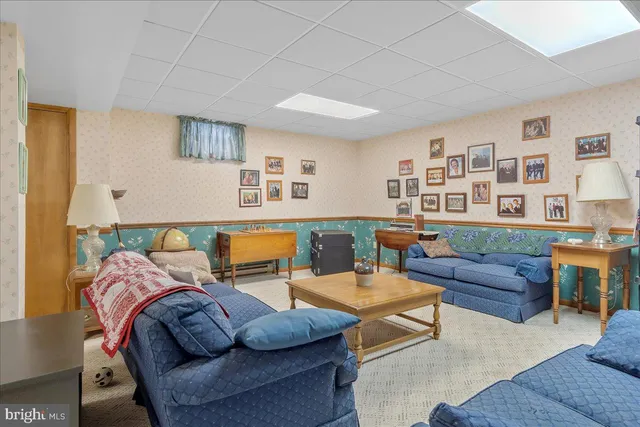 a living room with furniture and floor to ceiling windows