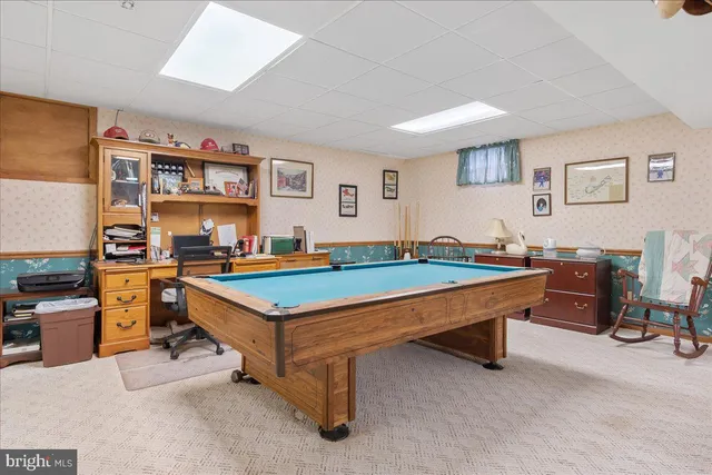a dining room with lots of tables a chandelier and living room view