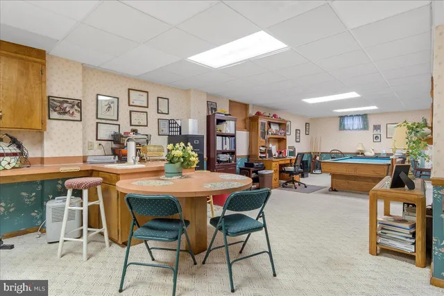 a dining room with furniture water view and large windows
