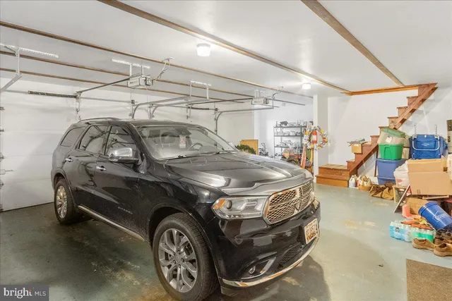 a view of a house with a big yard and large trees