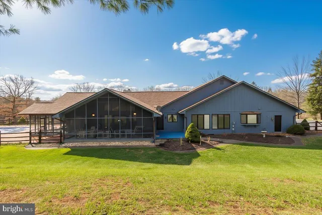 an aerial view of a residential houses covered in trees