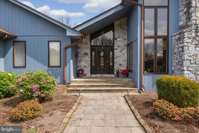 a living room with furniture a fireplace and a floor to ceiling window