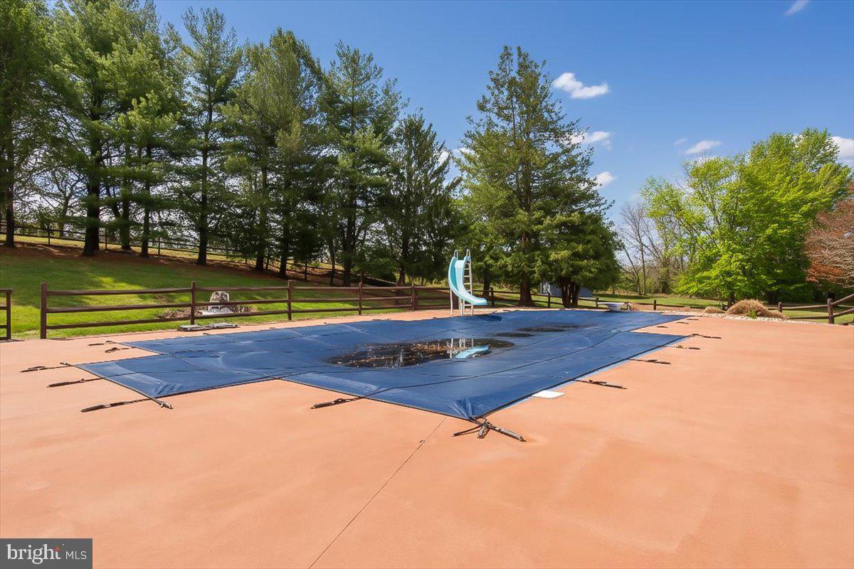 19850 Cool Hollow Road Hagerstown, MD 21740 - Photo 54 of 63 a view of a swimming pool with an outdoor space and seating area