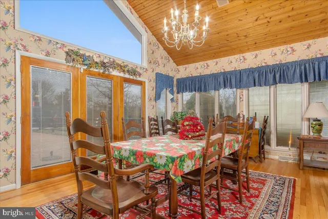 a living room with furniture a flat screen tv and a floor to ceiling window