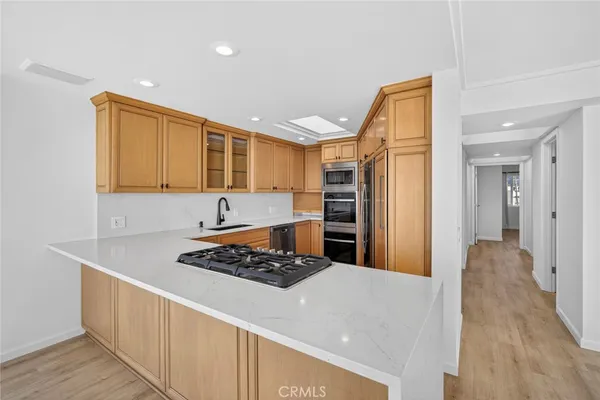a kitchen with stainless steel appliances a refrigerator and a stove