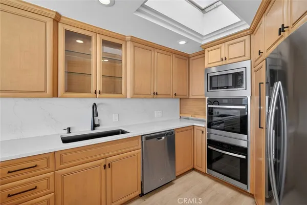 a kitchen with stainless steel appliances granite countertop a refrigerator and cabinets