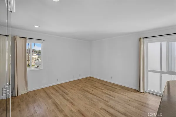 an empty room with wooden floor and a window