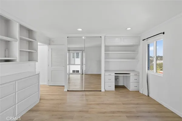 a view of a kitchen with wooden floor and a kitchen