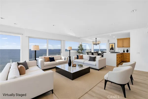 a living room with furniture and a view of kitchen