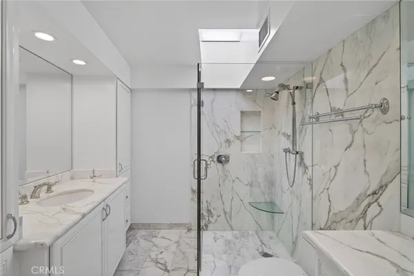 a spacious bathroom with a granite countertop sink a toilet and shower