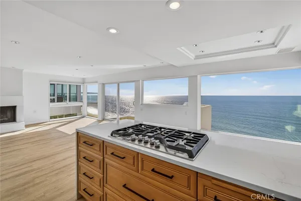a kitchen with granite countertop a stove and a wooden cabinets