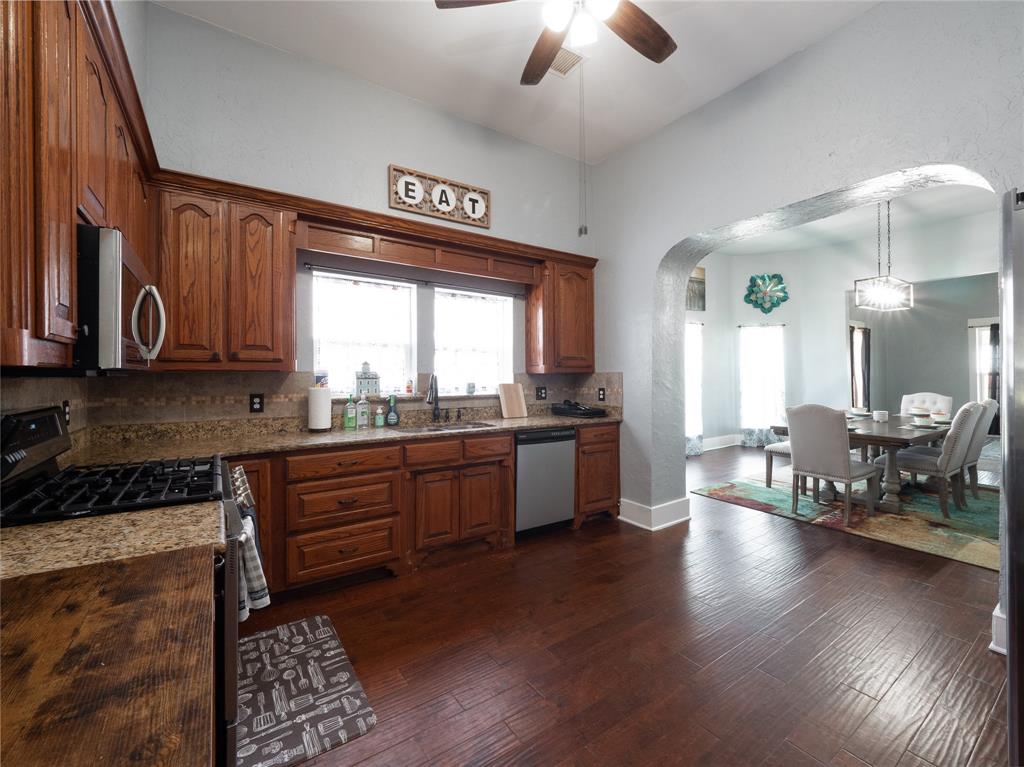7321 North State Highway Blue Ridge, TX 75424 - Photo 22 of 30 a large kitchen with stainless steel appliances granite countertop a lot of counter space and wooden floor