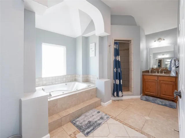 a bathroom with a tub sink and a mirror