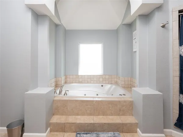 a bathroom with a bathtub and shower