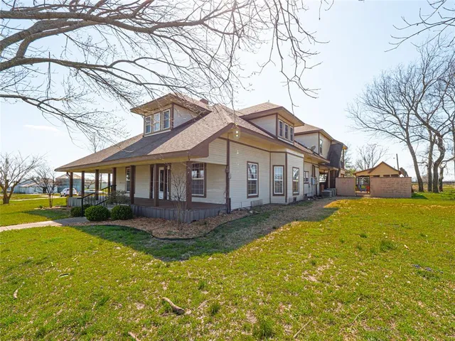 a front view of a house with yard and green space