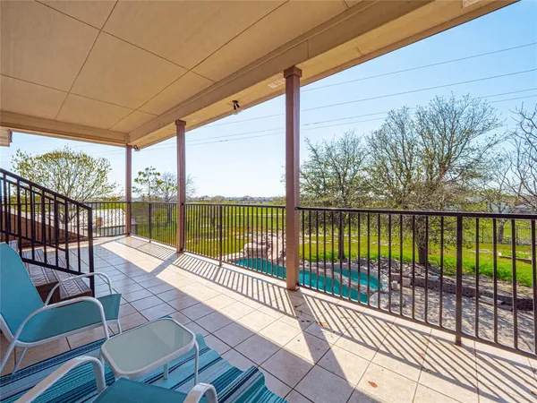 a balcony with wooden floor and outdoor space