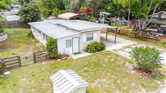 a view of a backyard with sitting area