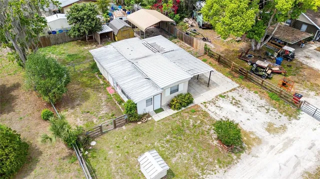 an aerial view of a house with a yard and garden
