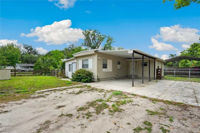 a view of a house with a backyard