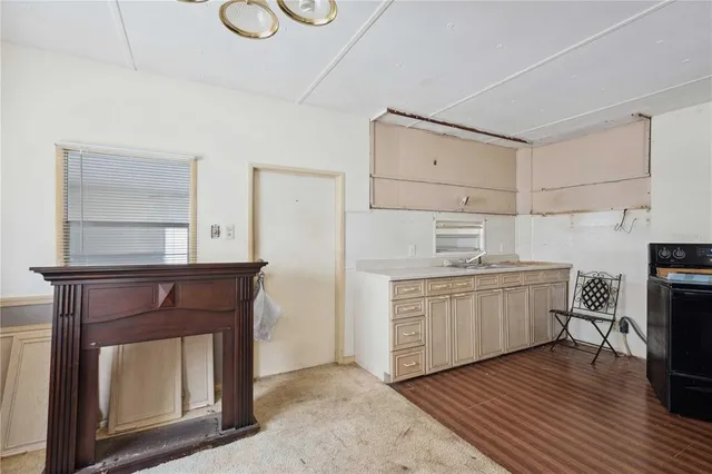 a kitchen with sink cabinets and wooden floor