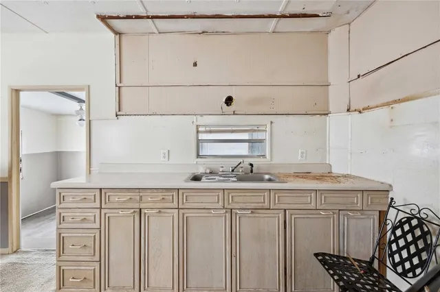a kitchen with sink cabinets and wooden floor