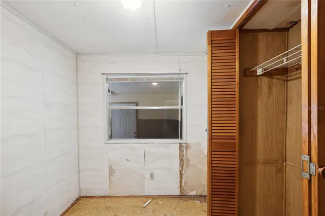 a view of a livingroom with an empty space and wooden floor
