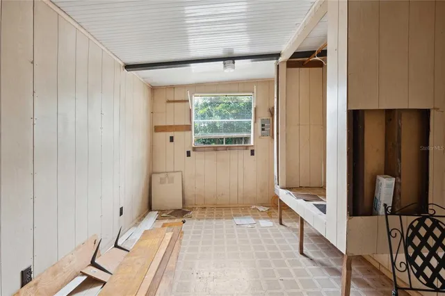 a bedroom with a bed and large window