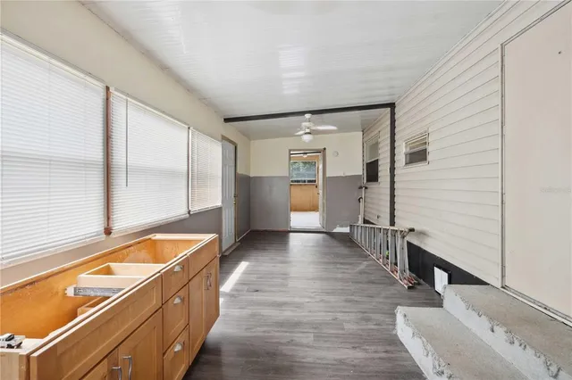 a view of a kitchen with a sink and refrigerator