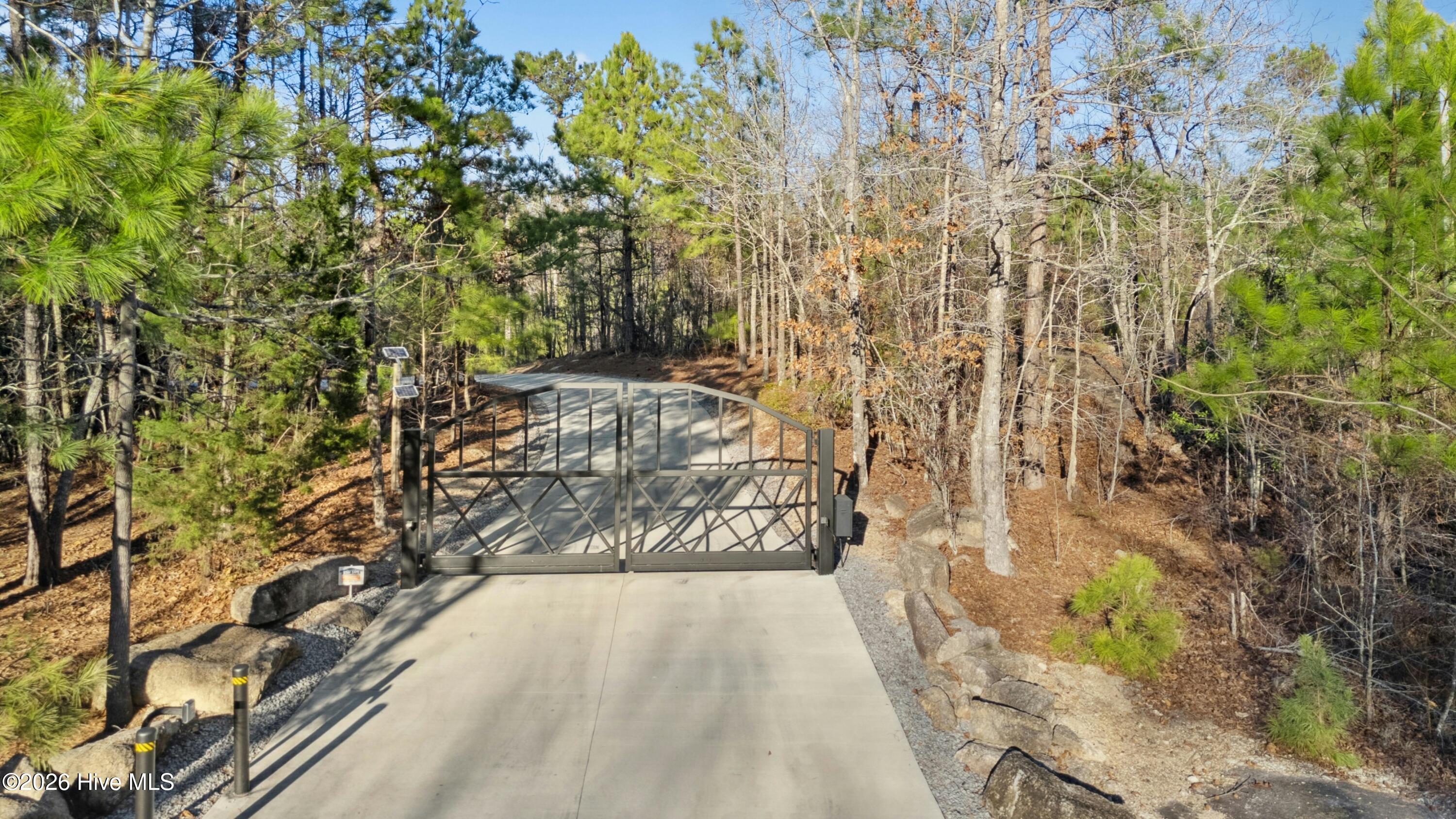 Gated estate. A gorgeous quarter-mile paved driveway winds through rolling woods to seclusion.