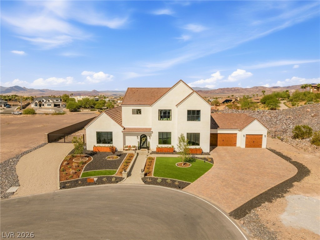 324 Wanda Road Henderson, NV 89002 - Photo 67 of 96 An elegant stucco facade harmonizes beautifully with paved driveways and clean desert landscaping.