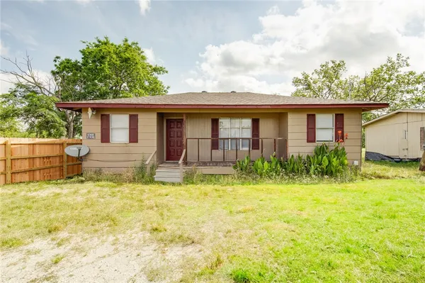 a front view of house with yard and porch