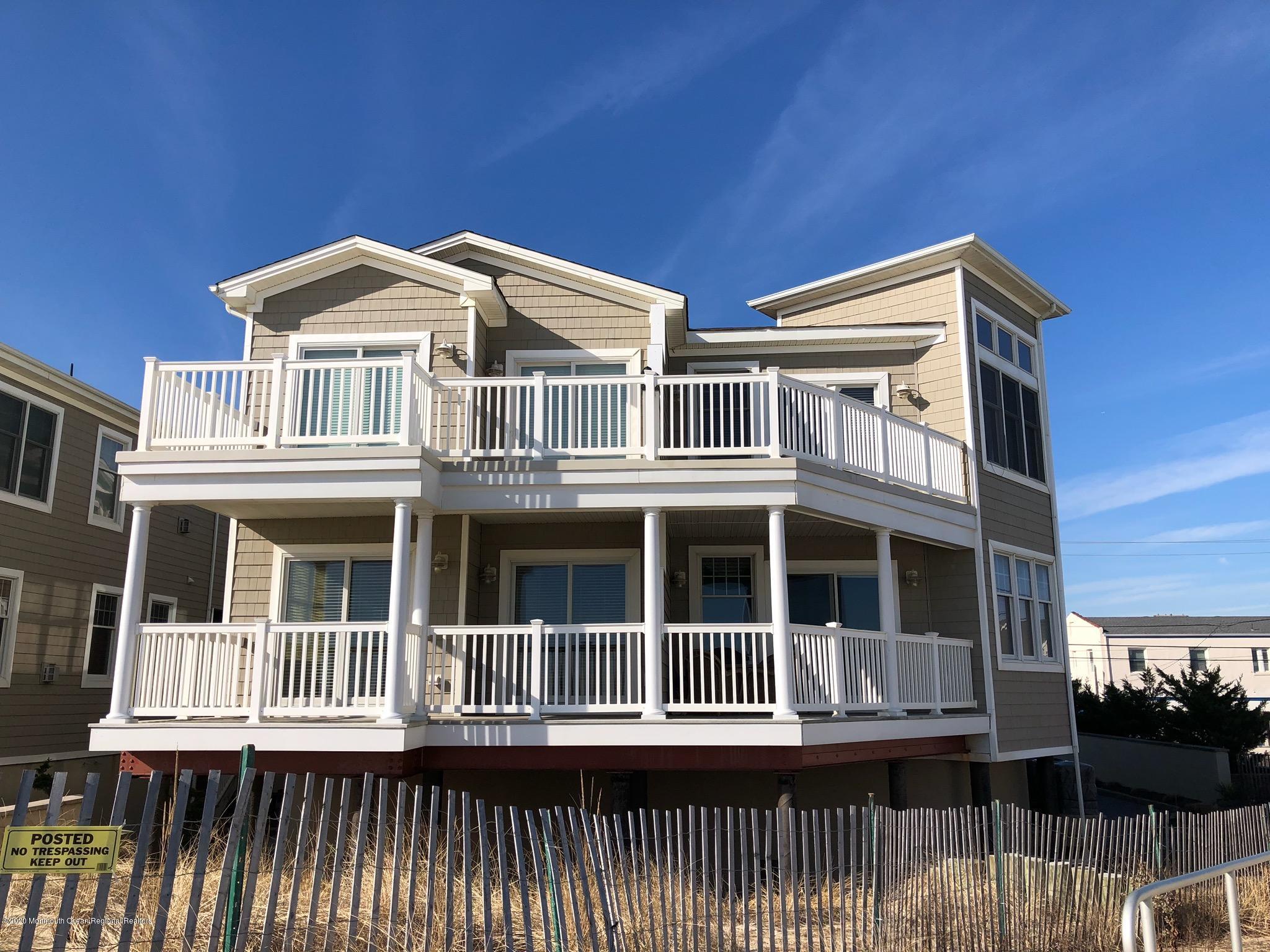 209 Beach Front, Unit 1 Manasquan, NJ 08736 - Photo 40 of 40 a front view of a house with a yard