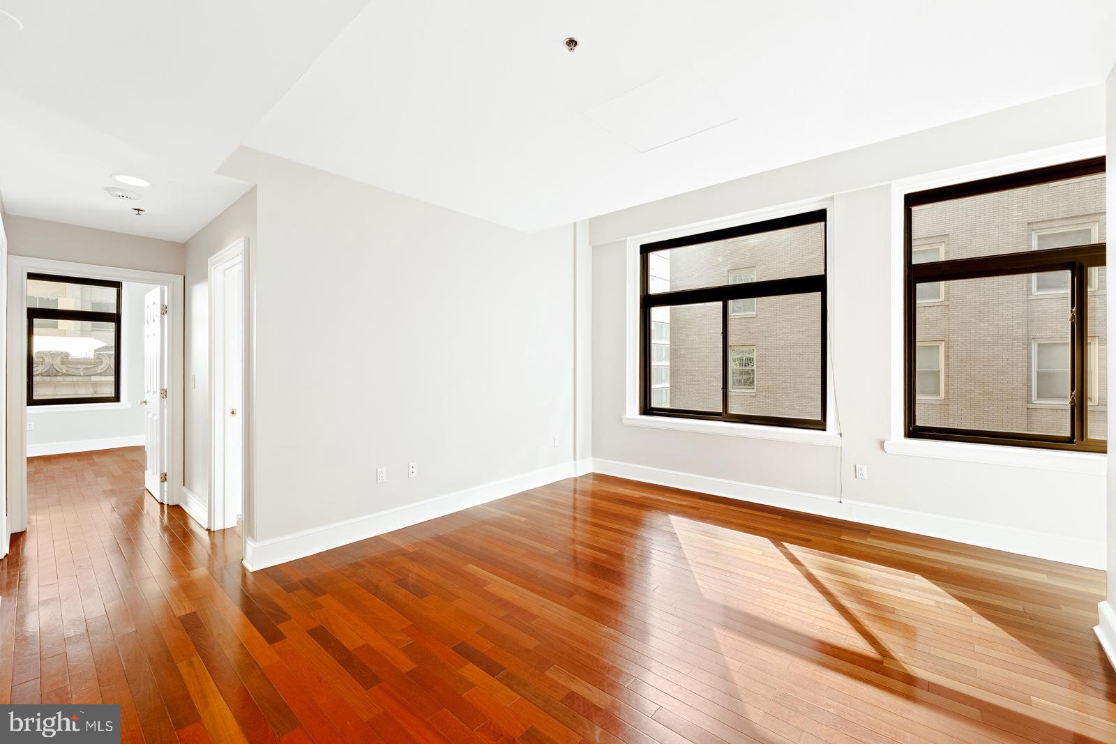 1500-00 Chestnut Street, Unit 19F Philadelphia, PA 19102 - Photo 14 of 33 a view of an empty room with wooden floor and a window