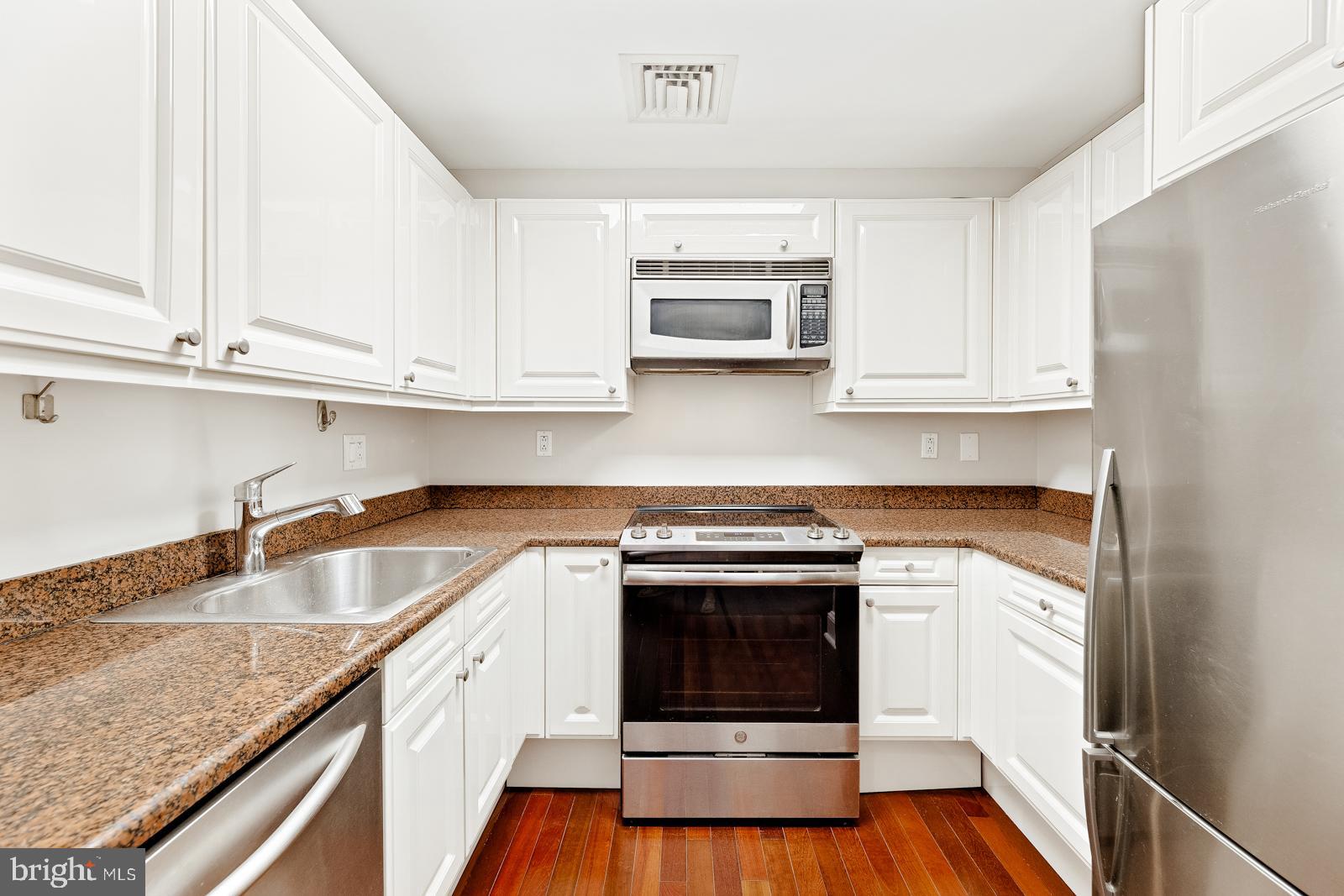 1500-00 Chestnut Street, Unit 19F Philadelphia, PA 19102 - Photo 21 of 33 a kitchen with appliances cabinets and a counter top space