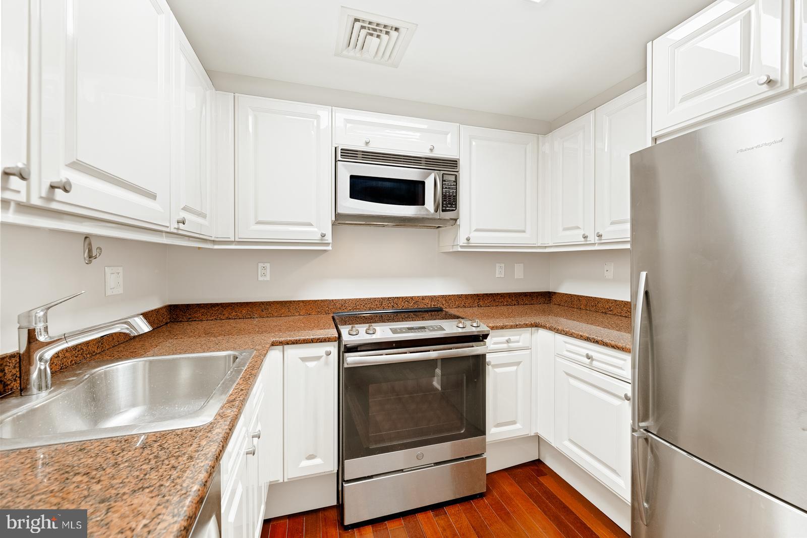 1500-00 Chestnut Street, Unit 19F Philadelphia, PA 19102 - Photo 22 of 33 a kitchen with granite countertop a sink stove and refrigerator