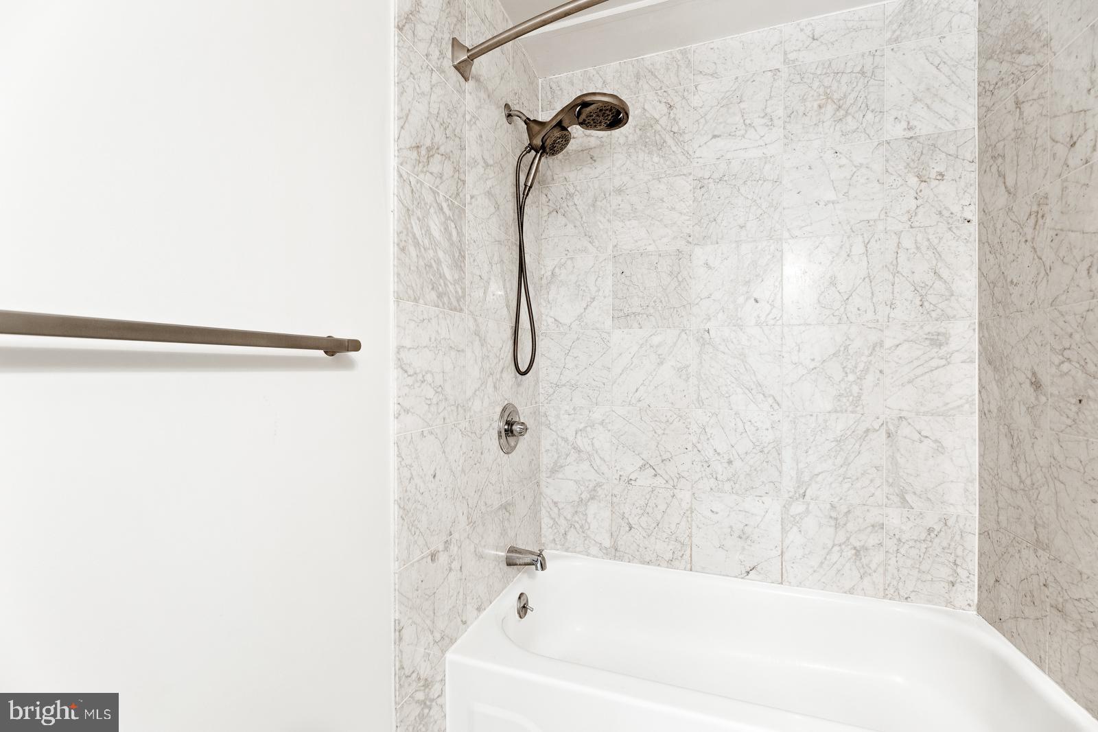 1500-00 Chestnut Street, Unit 19F Philadelphia, PA 19102 - Photo 25 of 33 a bathroom with a shower and a bath tub