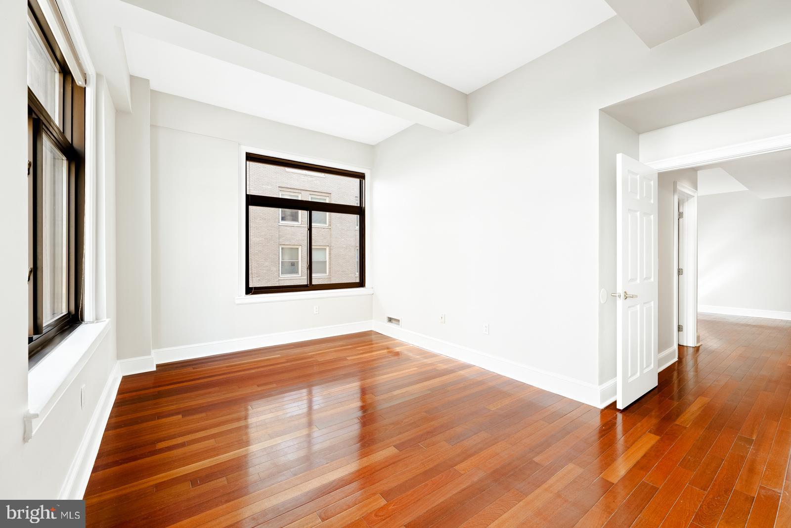 1500-00 Chestnut Street, Unit 19F Philadelphia, PA 19102 - Photo 27 of 33 a view of an empty room with wooden floor and a window