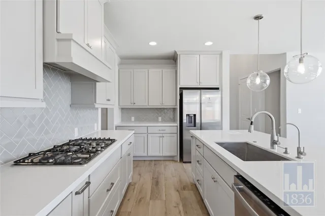 a kitchen with a sink stove and refrigerator