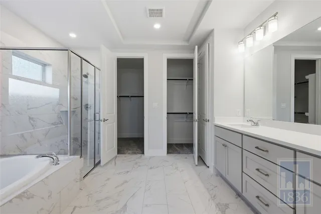 a bathroom with a double vanity sink mirror and shower