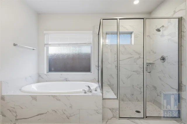 a bathroom with a bathtub and shower