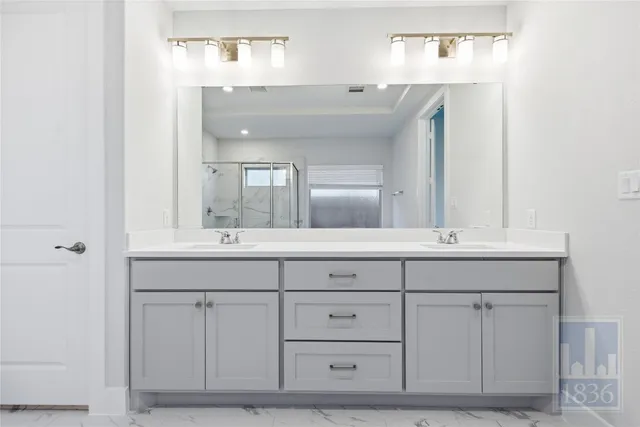 a bathroom with a sink vanity and mirror