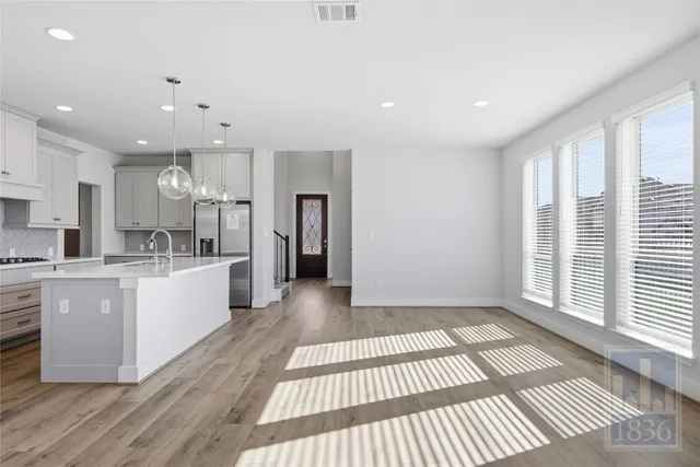 a large white kitchen with a large window