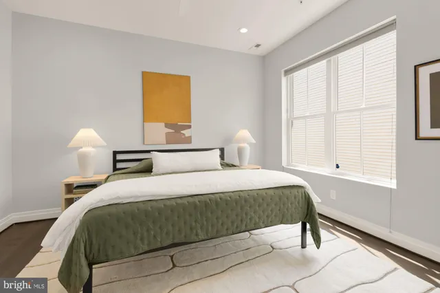 a bedroom with a bed and a table