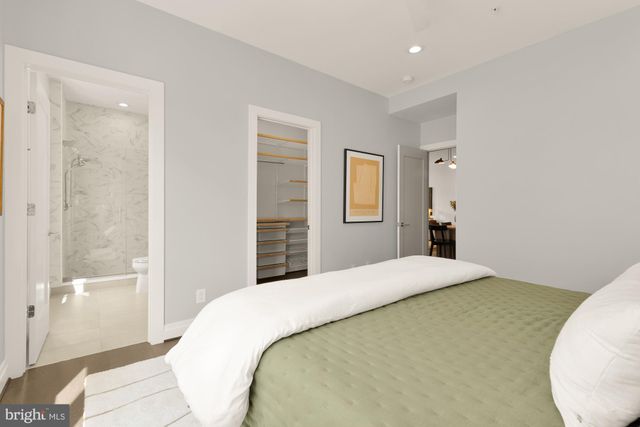 a bathroom with a sink toilet vanity and shower
