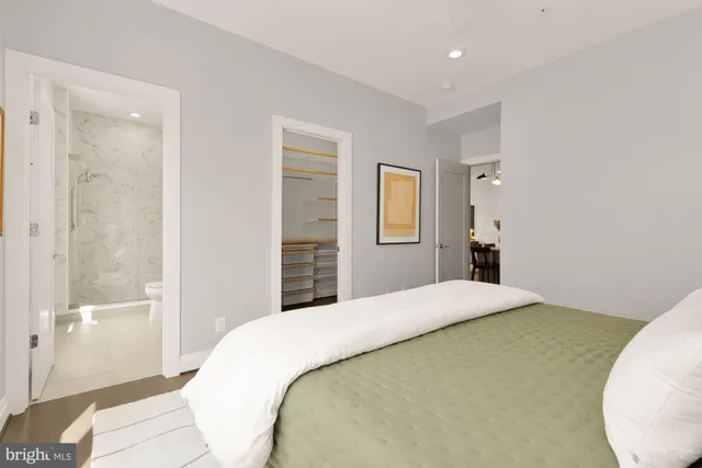 a bathroom with a sink toilet vanity and shower