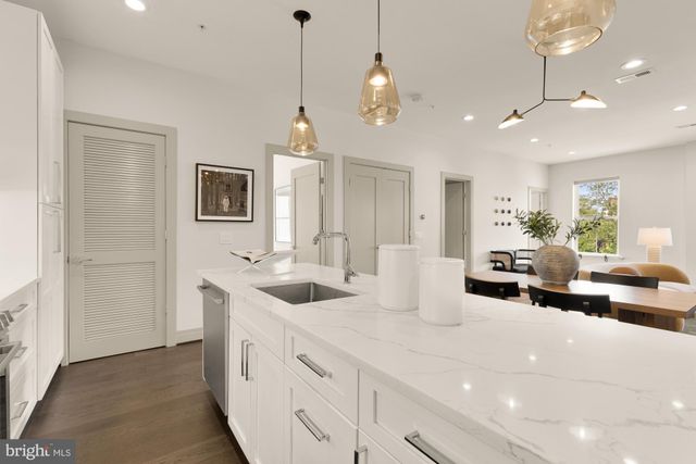 a very nice looking room with kitchen island furniture and a chandelier