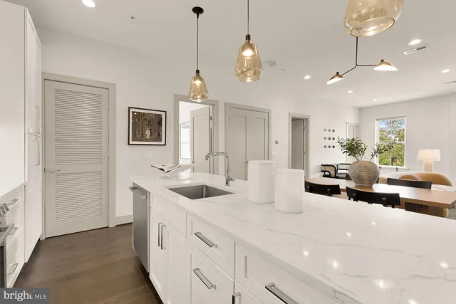 a very nice looking room with kitchen island furniture and a chandelier