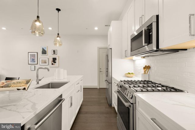 a kitchen that has a sink and a stove